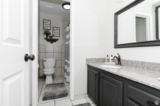 3704 S State St, Preston, ID 83263 - bathroom with tile patterned flooring, vanity, toilet, and tile walls