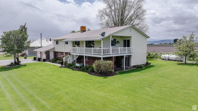 3704 S State St, Preston, ID 83263 - back of house with a lawn, metal roof, and a garage