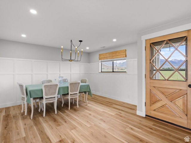 1491 Bryan Rd, Erda, UT 84074 - dining room featuring a decorative wall, a chandelier, light wood-type flooring, recessed lighting, and a wainscoted wall