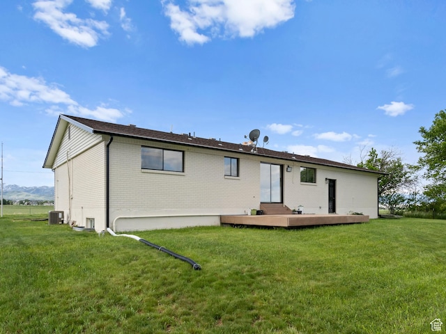 1491 Bryan Rd, Erda, UT 84074 - rear view of property featuring brick siding, central air condition unit, and a lawn