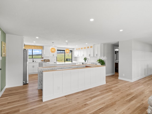 1491 Bryan Rd, Erda, UT 84074 - kitchen featuring appliances with stainless steel finishes, recessed lighting, light countertops, tasteful backsplash, and light wood-type flooring