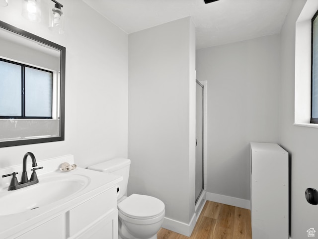 1491 Bryan Rd, Erda, UT 84074 - full bathroom featuring wood finished floors, a stall shower, toilet, and vanity