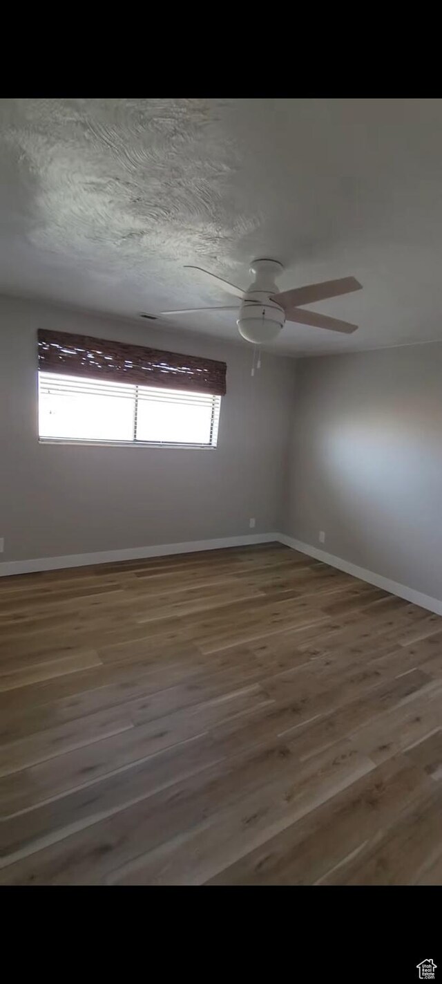 1491 Bryan Rd, Erda, UT 84074 - empty room featuring wood finished floors, baseboards, and ceiling fan