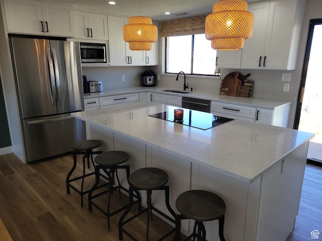 1491 Bryan Rd, Erda, UT 84074 - kitchen with stainless steel appliances, a sink, dark wood-type flooring, a center island, and recessed lighting