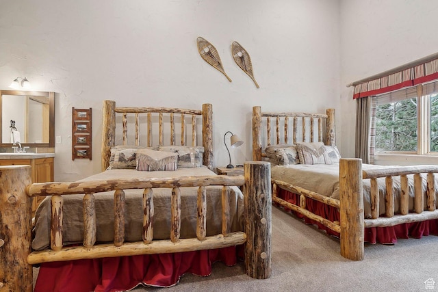 3975 Timberwolf Ln Unit 2C, Park City, UT 84098 - carpeted bedroom featuring a sink, ensuite bathroom, and a towering ceiling