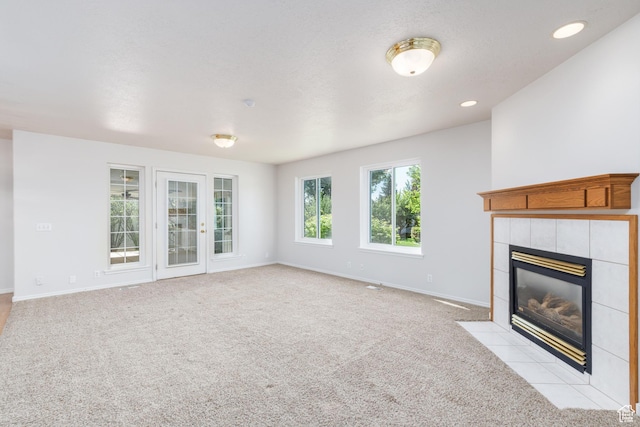 2275 W 1500 S Unit 28, Syracuse, UT 84075 - unfurnished living room featuring a tile fireplace, light carpet, baseboards, and recessed lighting