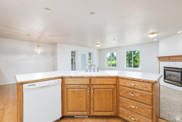 2275 W 1500 S Unit 28, Syracuse, UT 84075 - kitchen featuring dishwasher, a sink, light countertops, a fireplace, and light wood finished floors