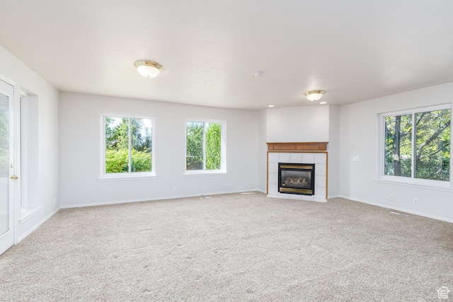 2275 W 1500 S Unit 28, Syracuse, UT 84075 - unfurnished living room featuring light carpet, a fireplace, and baseboards