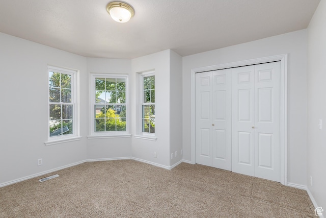 2275 W 1500 S Unit 28, Syracuse, UT 84075 - unfurnished bedroom featuring carpet, baseboards, and a closet