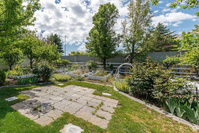 2275 W 1500 S Unit 28, Syracuse, UT 84075 - fenced backyard featuring a garden and a patio area