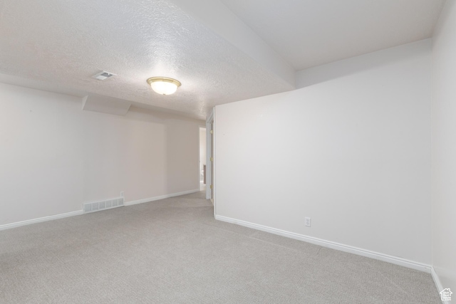 2275 W 1500 S Unit 28, Syracuse, UT 84075 - unfurnished room with light colored carpet, a textured ceiling, and baseboards