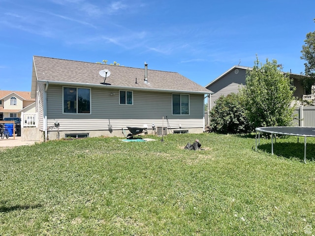 524 W 860 S, Tremonton, UT 84337 - back of house featuring a trampoline and a lawn