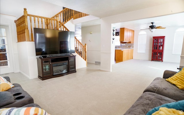 398 S 900 E, Smithfield, UT 84335 - living area with stairs, ceiling fan, light tile patterned flooring, baseboards, and light colored carpet