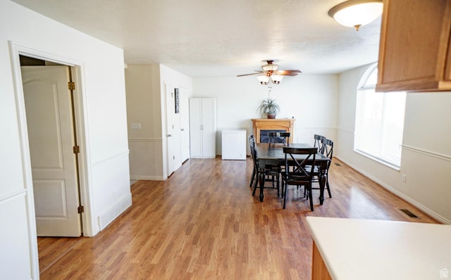 398 S 900 E, Smithfield, UT 84335 - dining area with a ceiling fan, light wood-style floors, baseboards, and a fireplace