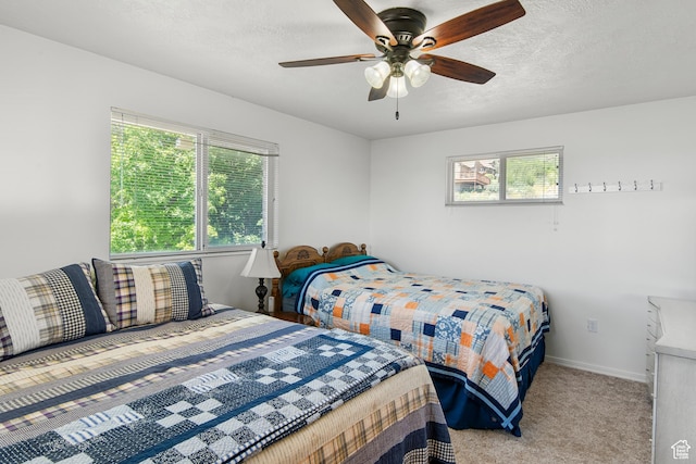 27 Lake W Cir, Fish Haven, ID 83287 - bedroom with multiple windows, carpet, a textured ceiling, a ceiling fan, and baseboards