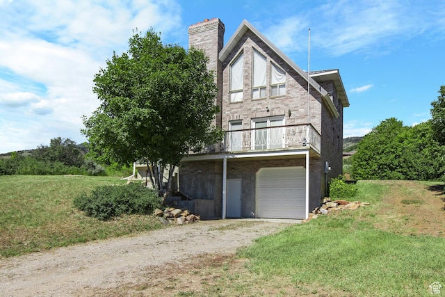 27 Lake W Cir, Fish Haven, ID 83287 - view of property exterior with a chimney, driveway, stone siding, and an attached garage