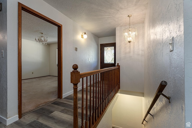 437 S 100 W, Kanab, UT 84741 - stairs featuring a chandelier, wood finished floors, a textured ceiling, and a textured wall