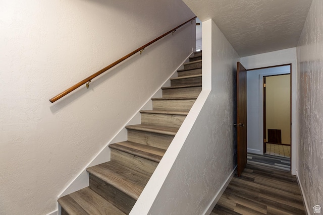 437 S 100 W, Kanab, UT 84741 - stairway featuring baseboards, wood finished floors, a textured wall, and a textured ceiling