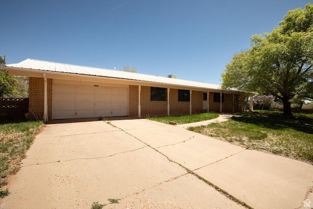 437 S 100 W, Kanab, UT 84741 - ranch-style house with brick siding, a garage, driveway, and a front lawn