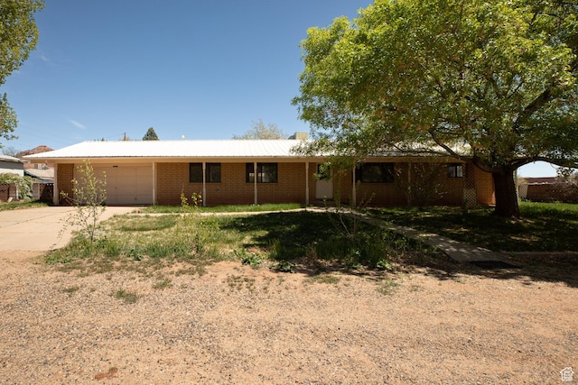 437 S 100 W, Kanab, UT 84741 - ranch-style home featuring an attached garage, concrete driveway, and brick siding