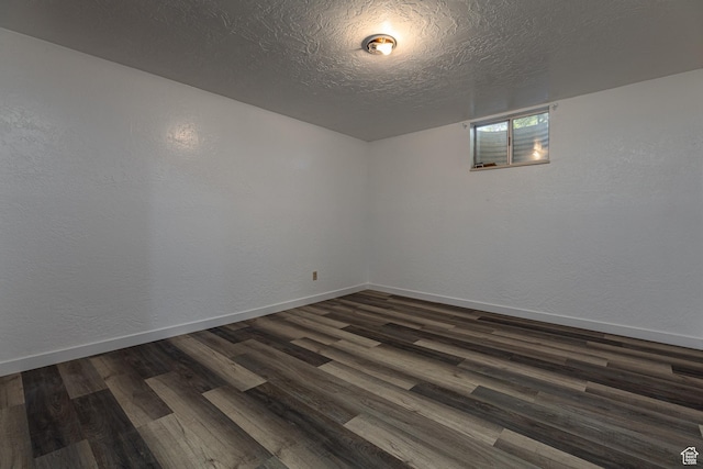 437 S 100 W, Kanab, UT 84741 - unfurnished room featuring dark wood-type flooring, baseboards, a textured ceiling, and a textured wall