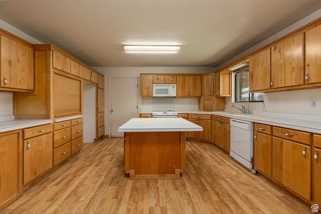 437 S 100 W, Kanab, UT 84741 - kitchen with white appliances, light wood-style floors, light countertops, a kitchen island, and brown cabinets