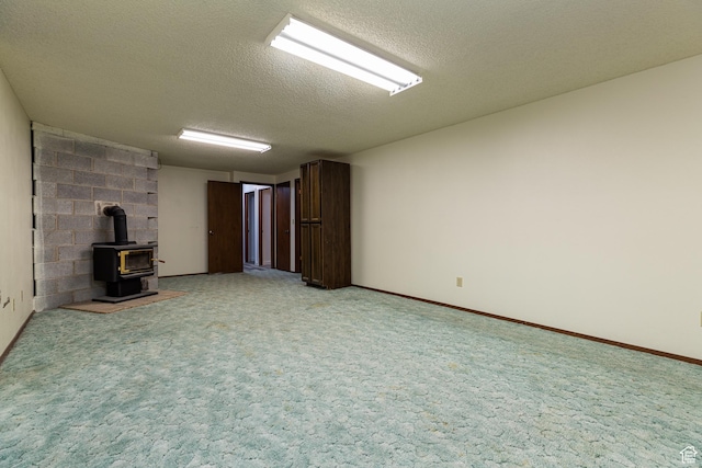 437 S 100 W, Kanab, UT 84741 - unfurnished living room with a wood stove, a textured ceiling, and light colored carpet