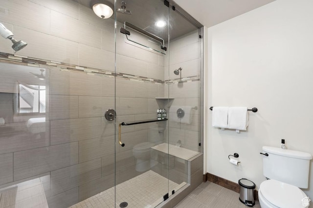 14311 N Buck Horn Trl Unit 42N, Kamas, UT 84036 - bathroom with tile patterned floors, toilet, a shower stall, and baseboards