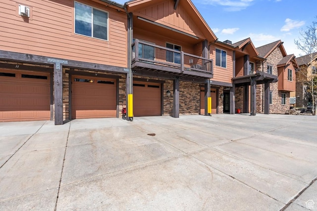 14311 N Buck Horn Trl Unit 42N, Kamas, UT 84036 - view of front of property featuring a garage, driveway, stone siding, and board and batten siding