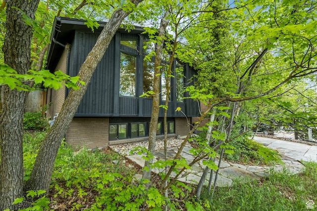 2634 S Cave Hollow Way, Bountiful, UT 84010 - view of home's exterior with brick siding, board and batten siding, and a patio