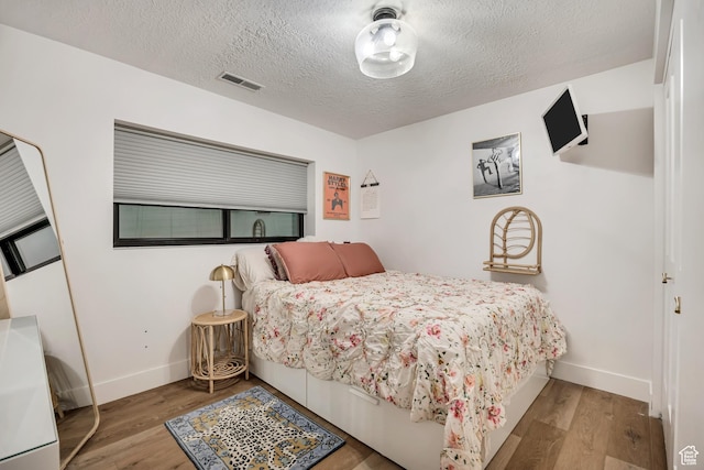 2634 S Cave Hollow Way, Bountiful, UT 84010 - bedroom with wood finished floors, baseboards, and a textured ceiling
