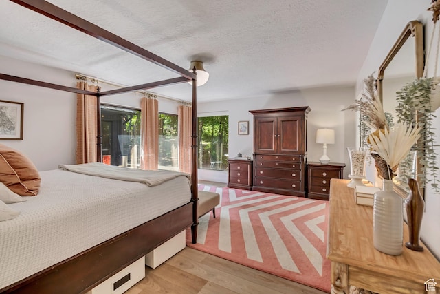 2634 S Cave Hollow Way, Bountiful, UT 84010 - bedroom featuring light wood-style flooring and a textured ceiling