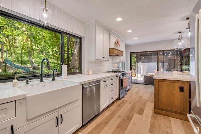 2634 S Cave Hollow Way, Bountiful, UT 84010 - kitchen with appliances with stainless steel finishes, a sink, white cabinetry, light countertops, and recessed lighting