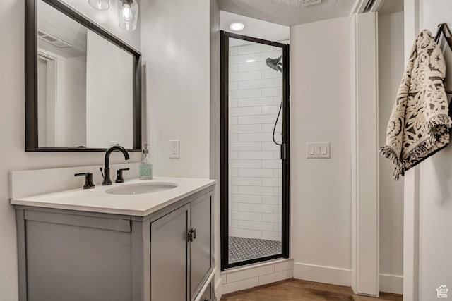 2634 S Cave Hollow Way, Bountiful, UT 84010 - bathroom with a stall shower, vanity, wood finished floors, and baseboards