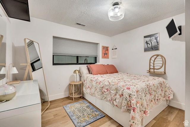 2634 S Cave Hollow Way, Bountiful, UT 84010 - bedroom with a textured ceiling, wood finished floors, and baseboards