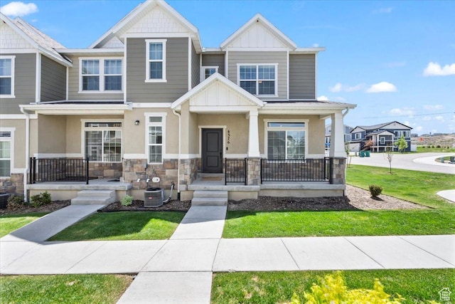 4376 W Bromwell Ct, Lehi, UT 84043 - view of property with a porch, stone siding, board and batten siding, and a front lawn