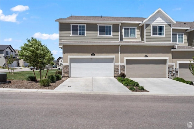 4376 W Bromwell Ct, Lehi, UT 84043 - view of front facade featuring stone siding, driveway, an attached garage, and stucco siding