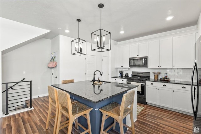 4376 W Bromwell Ct, Lehi, UT 84043 - kitchen with gas stove, a sink, white cabinetry, a kitchen bar, and dark wood finished floors
