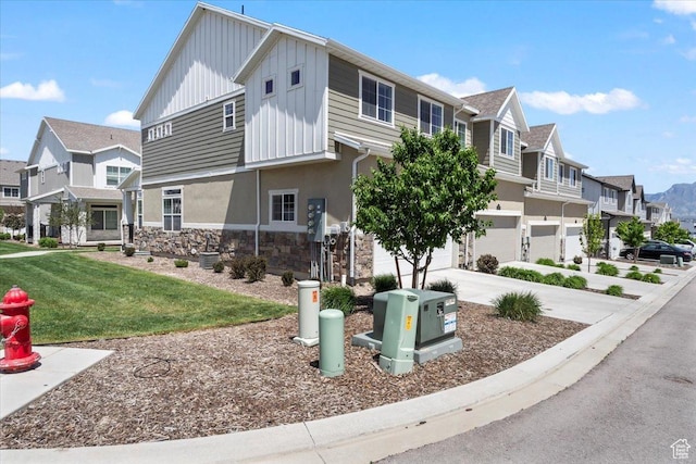 4376 W Bromwell Ct, Lehi, UT 84043 - view of front of house featuring board and batten siding, stone siding, an attached garage, and a residential view