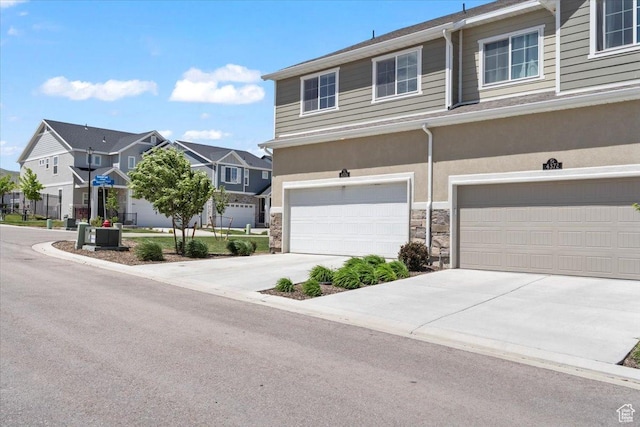 4376 W Bromwell Ct, Lehi, UT 84043 - view of property featuring a residential view, stone siding, driveway, and an attached garage