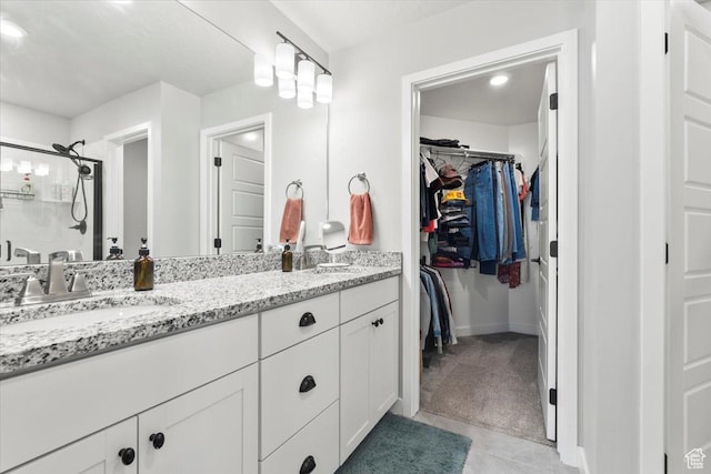 4376 W Bromwell Ct, Lehi, UT 84043 - bathroom featuring a walk in closet, double vanity, tile patterned floors, baseboards, and a shower