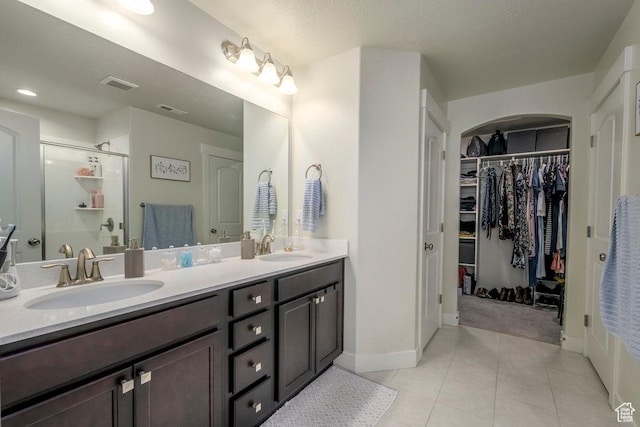 2068 N 3830 W, Lehi, UT 84043 - full bath with a shower stall, baseboards, tile patterned flooring, double vanity, and a walk in closet