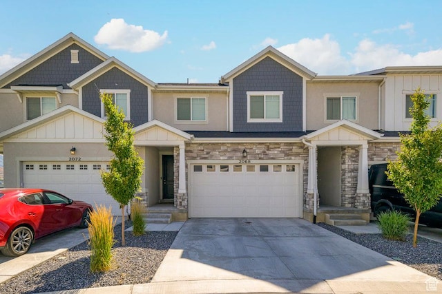 2068 N 3830 W, Lehi, UT 84043 - view of front of house featuring board and batten siding, driveway, an attached garage, and stone siding