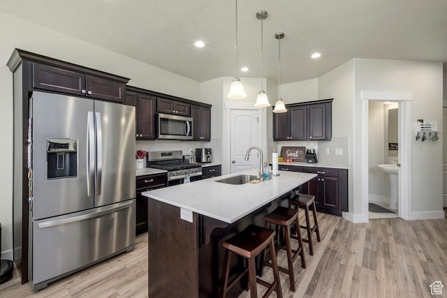 2068 N 3830 W, Lehi, UT 84043 - kitchen featuring appliances with stainless steel finishes, a sink, light wood-style flooring, light countertops, and recessed lighting