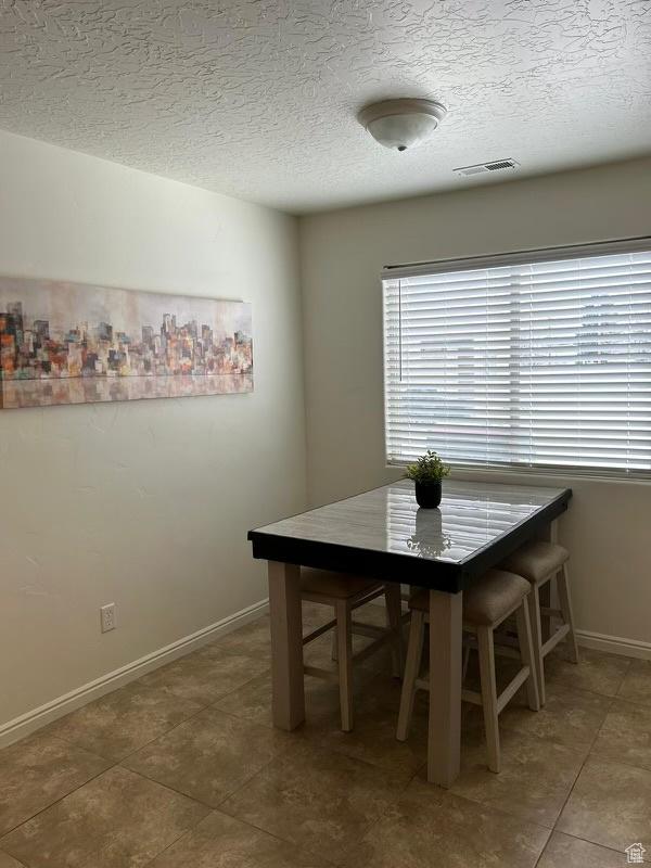 672 N 100 W, Vernal, UT 84078 - tiled dining area with a textured ceiling and baseboards