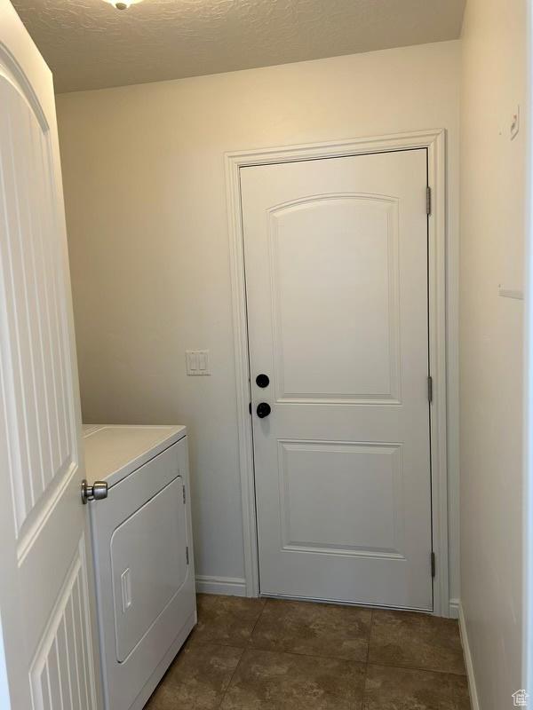 672 N 100 W, Vernal, UT 84078 - washroom with washer / clothes dryer and dark tile patterned flooring