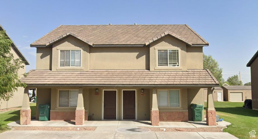 672 N 100 W, Vernal, UT 84078 - traditional-style house with stucco siding, a front yard, a porch, and stone siding