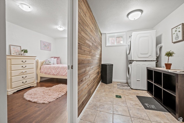 430 W 550 N, Logan, UT 84321 - washroom with stacked washer and clothes dryer, a textured ceiling, wood walls, and baseboards