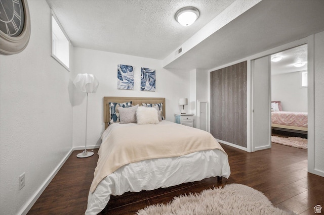 430 W 550 N, Logan, UT 84321 - bedroom featuring baseboards, a textured ceiling, and wood finished floors