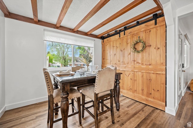 430 W 550 N, Logan, UT 84321 - dining room with beam ceiling, wood finished floors, baseboards, and a barn door